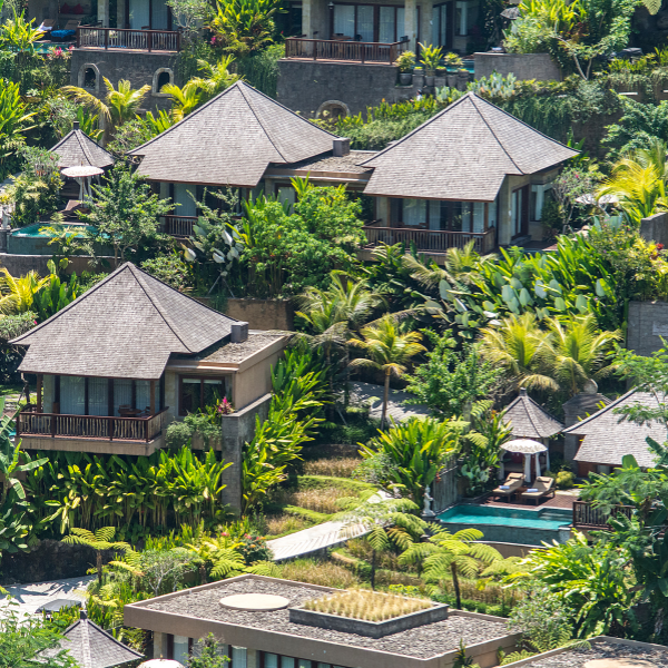 Picture of a resort and hotel with well-maintained trees.